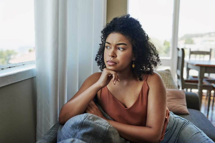 Young woman looking out of the window